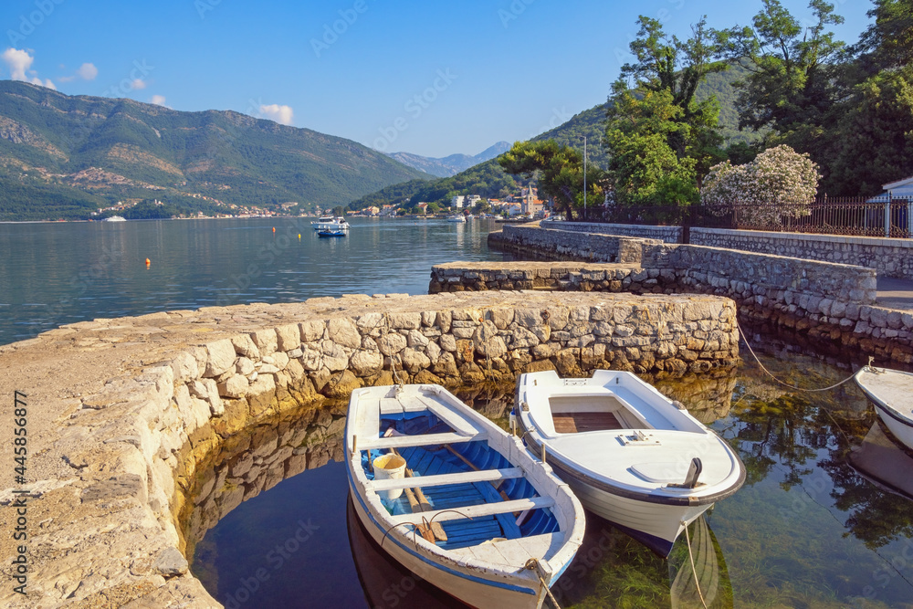 Beautiful summer Mediterranean landscape with fishing boats in small harbor. Montenegro, Adriatic Sea, Bay of Kotor. Donja Lastva village near Tivat  city