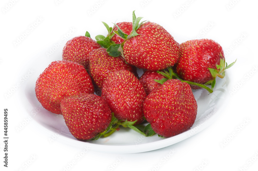 Fresh red strawberries on white plate. Isolated on white Fresh red strawberries on white plate. Isolated on white