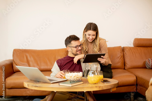 Young couple using laptop t...