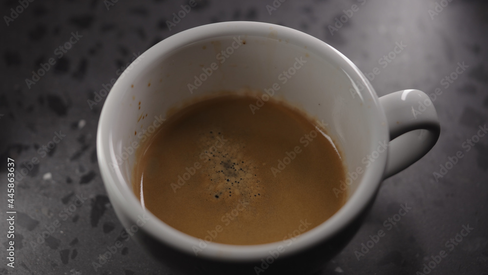 Making cappuccino, pour steamed milk into white cup with espresso Making cappuccino, pour steamed milk into white cup with espresso