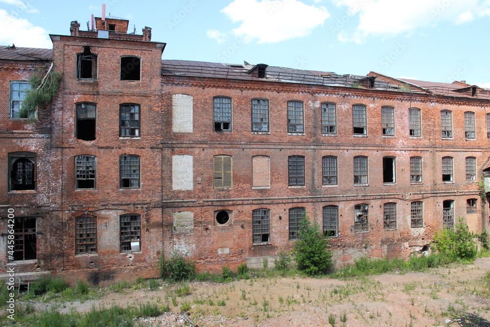 View from window of old abandoned red brick building on another wall in backyard in sunny summer day View from window of old abandoned red brick building on another wall in backyard in sunny summer day