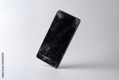 Mobile phone in equilibrium with a very broken screen and the circuitry coming out of the corners