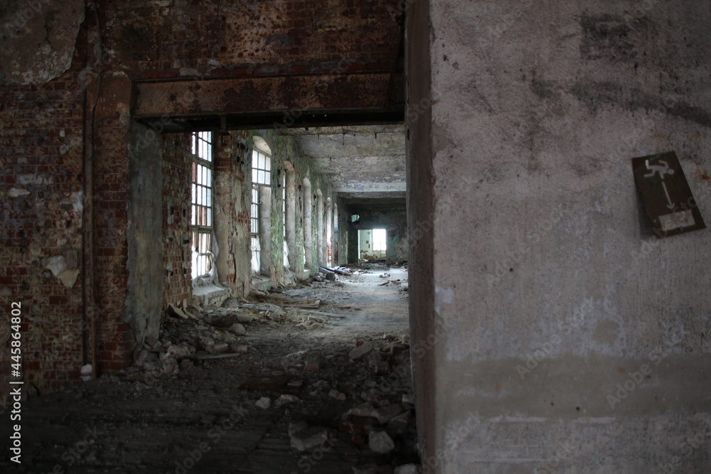 Corridor with windows in old abandobed factory