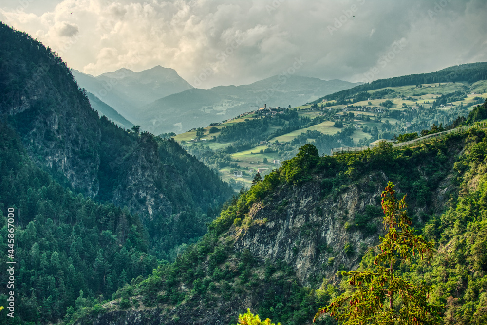 Fototapeta premium sunset over the mountains in Trentino Alto Adige with vineyards and orchards