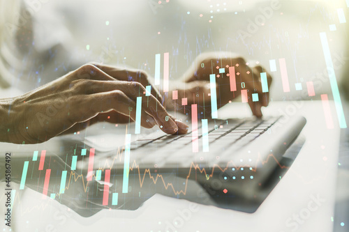 Double exposure of abstract creative financial chart with hand typing on computer keyboard on background  research and strategy concept