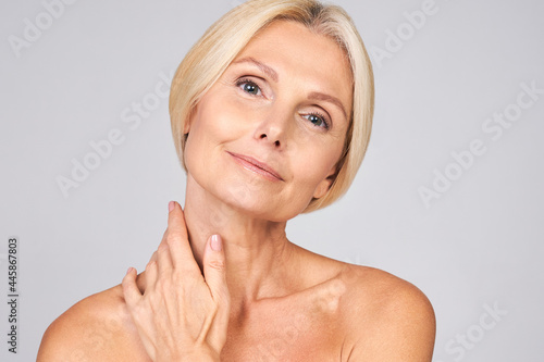 Cute mature lady is enjoying her perfect skin.