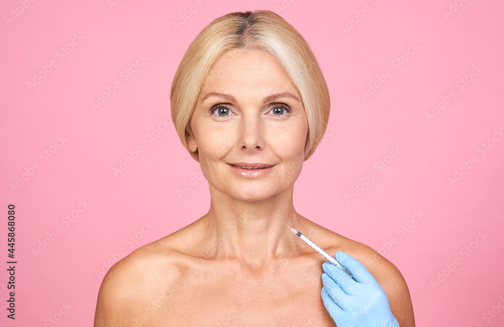 Woman, mature age beauty, giving medical injection. Woman, mature age beauty, giving medical injection.