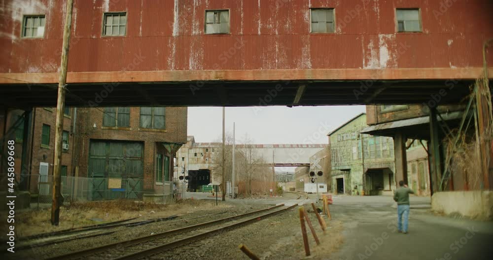 A Man Walks At An Abandoned Factory During Winter Time In Derby, Connecticut A Man Walks At An Abandoned Factory During Winter Time In Derby, Connecticut