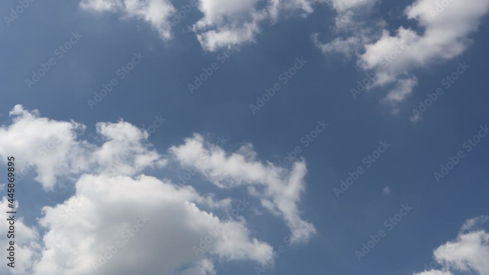 The movement of fluffy white clouds. On the airy background of the blue sky, time lapse The movement of fluffy white clouds. On the airy background of the blue sky, time lapse