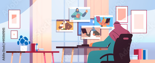 arab businessman discussing with colleagues in web browser windows during video call virtual conference