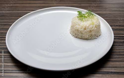 Closeup shot of a half-empty white plate with a rice side dish