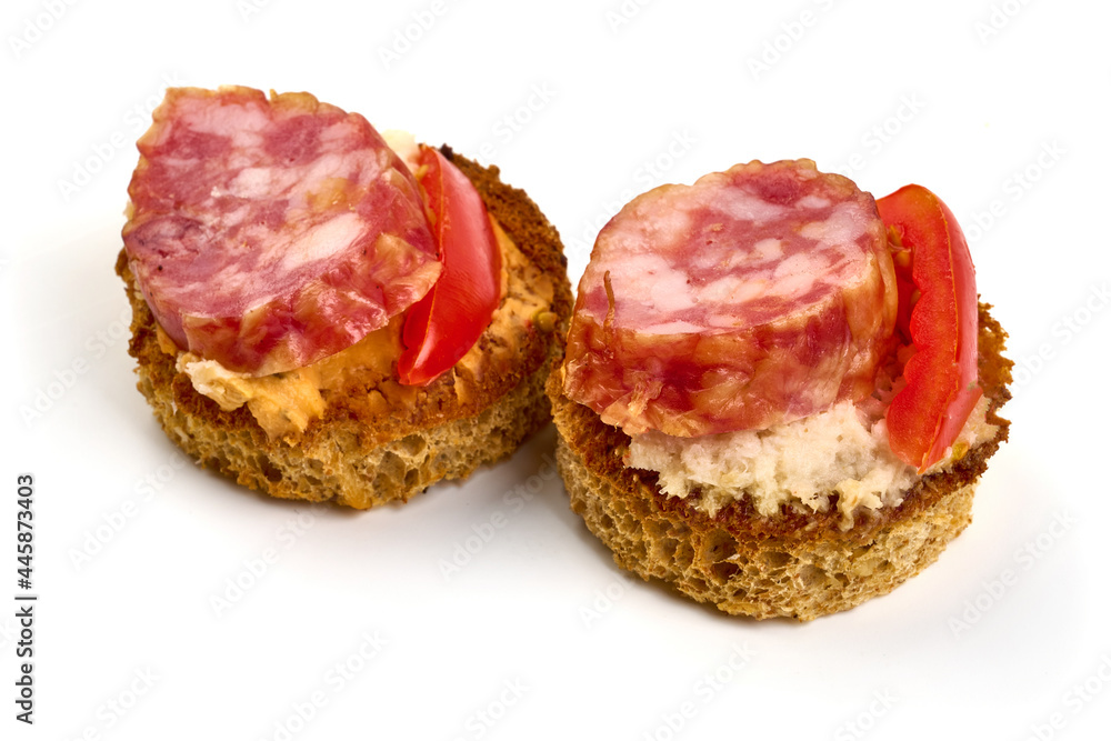 Bruschetta with fuet sausage, isolated on white background. High resolution image.