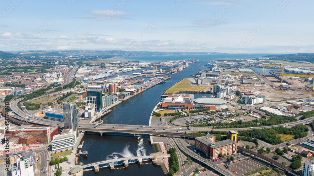 Obraz premium Aerial view on river and buildings in City center of Belfast Northern Ireland. Drone photo, high angle view of town