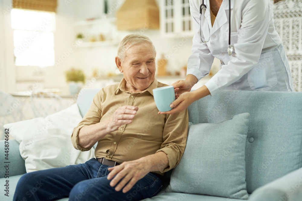 Elderly man going to drink a hot drink at home Elderly man going to drink a hot drink at home