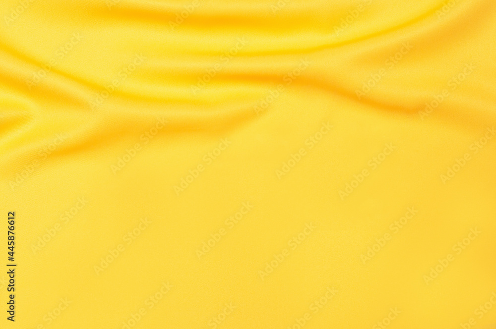 Smooth elegant yellow tissue abstract background. Textile background. Cloth wallpaper. Graphics design element Smooth elegant yellow tissue abstract background. Textile background. Cloth wallpaper. Graphics design element