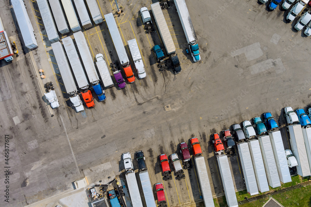 Top view car parking for heavy trucks stop on rest area in the highway trucks stand in a row Top view car parking for heavy trucks stop on rest area in the highway trucks stand in a row