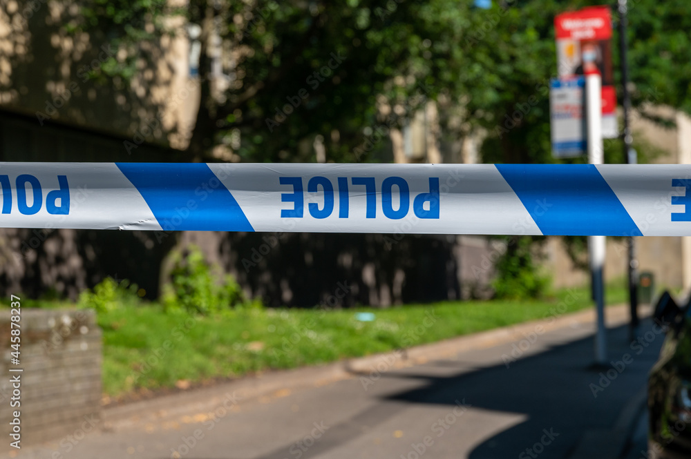 Obraz premium Upside down police cordon tape across a crime scene