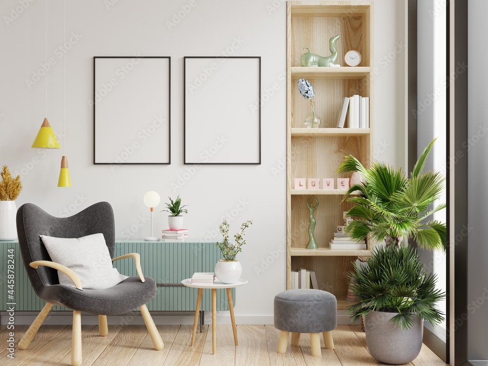 Fototapeta premium Two poster mockup with vertical frames on empty white wall in living room interior and armchair.
