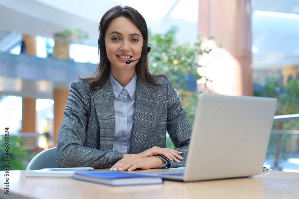 Woman customer support operator with headset and smiling. Woman customer support operator with headset and smiling.