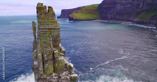 Aerial: Ocean, birds flying and rocky coastline. Cliffs of Moher, Ireland photo