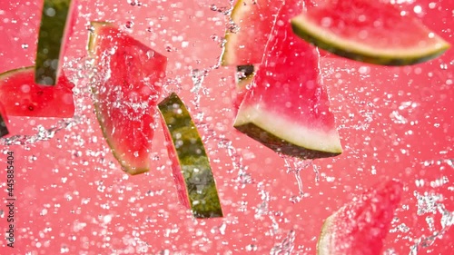 Super Slow Motion Shot of Flying Fresh Melon Cuts and Water Side Splash at 1000 fps. photo
