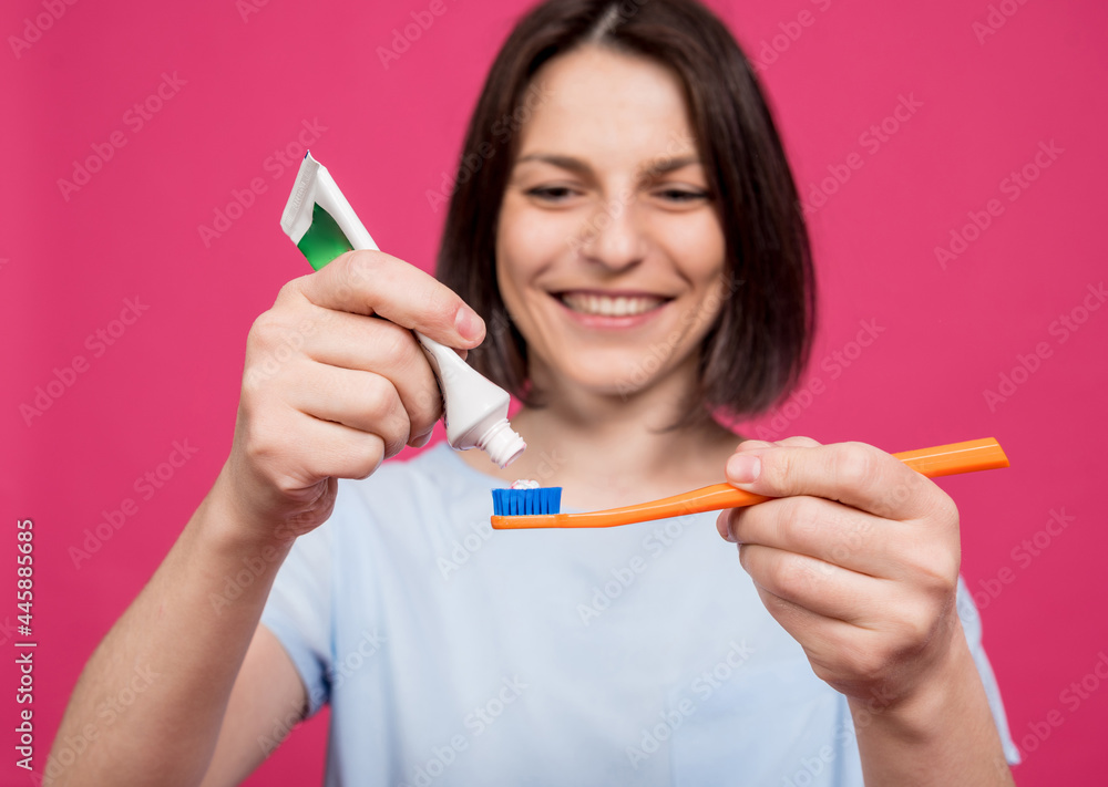 Beautiful happy young woman with toothbrush on blank pink background Beautiful happy young woman with toothbrush on blank pink background