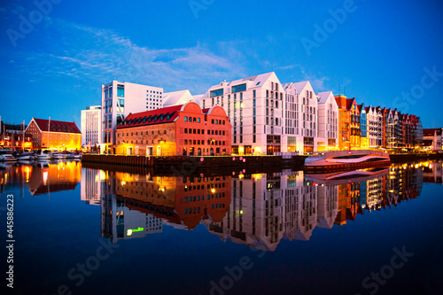 Evening lights reflects in river in Gdansk, old town.