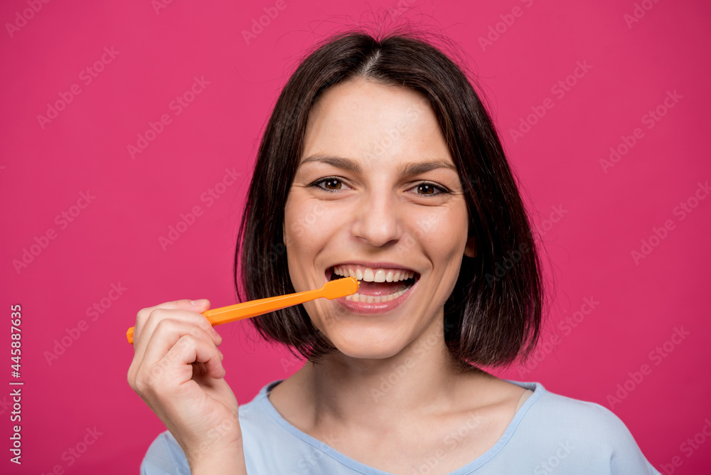 Beautiful happy young woman with toothbrush on blank pink background Beautiful happy young woman with toothbrush on blank pink background