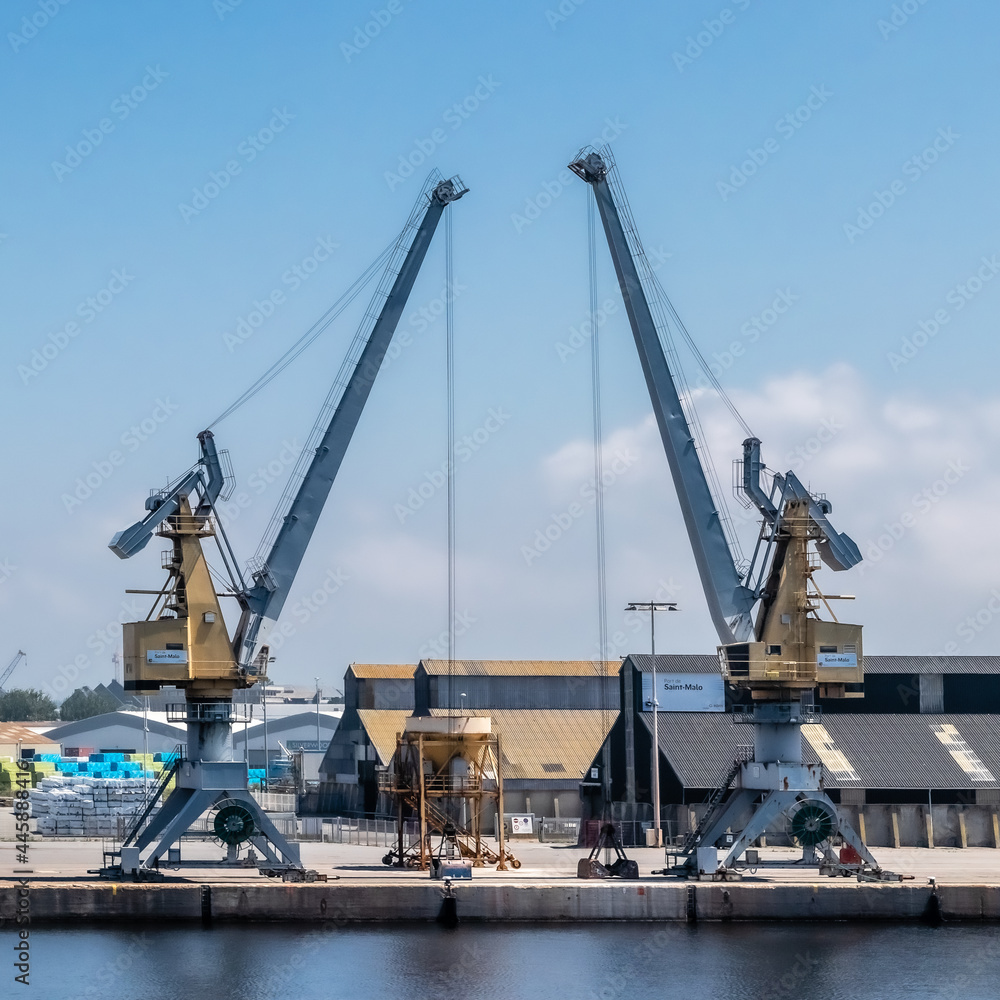 two construction cranes facing each other