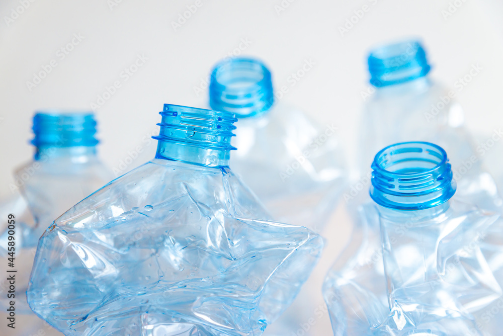 Crushed or crumpled clear plastic bottles. Plastic waste. Plastic recycling. Plastic pollution and waste management. 