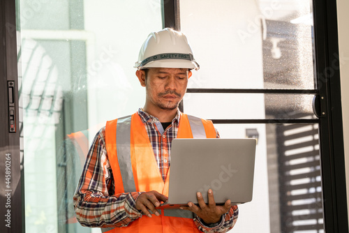 male engineer Working tools Engineer office desk with helmet at desk talbe photo