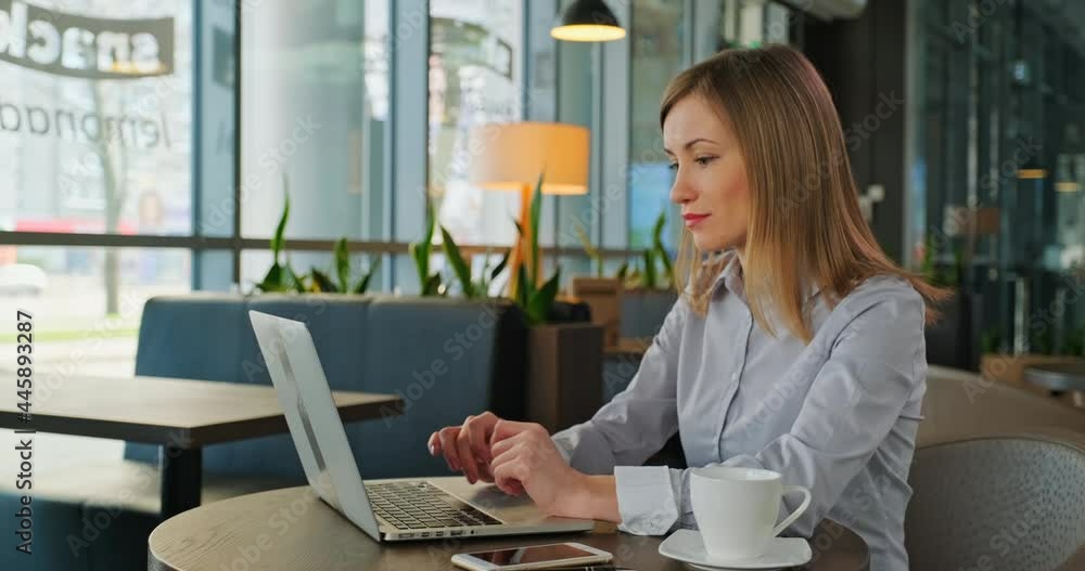 Young woman using laptop in restaurant. Dolly shot Young woman using laptop in restaurant. Dolly shot