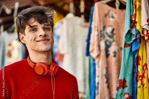 Young hispanic man smiling happy shopping at the store