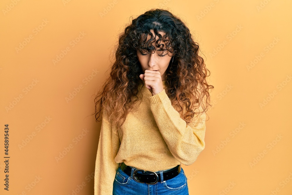 Young hispanic girl wearing casual clothes feeling unwell and coughing as symptom for cold or bronchitis. health care concept. Young hispanic girl wearing casual clothes feeling unwell and coughing as symptom for cold or bronchitis. health care concept.