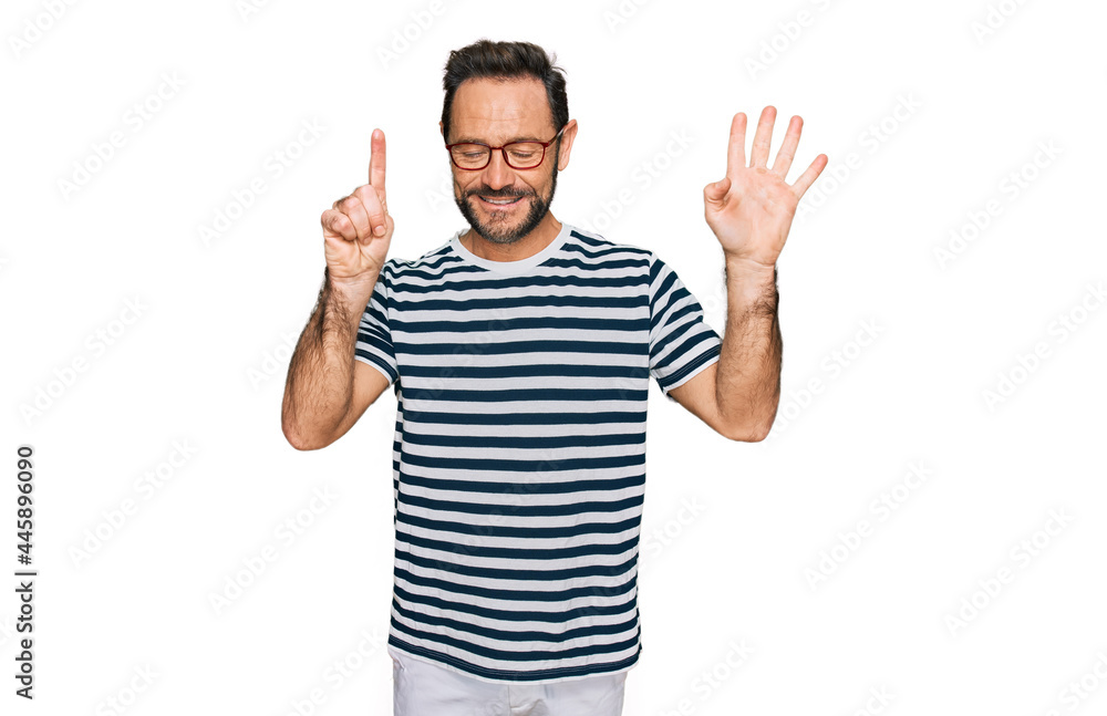 Middle age man wearing casual clothes and glasses showing and pointing up with fingers number six while smiling confident and happy. Middle age man wearing casual clothes and glasses showing and pointing up with fingers number six while smiling confident and happy.