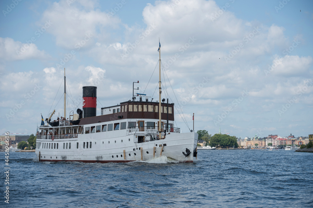 Old steam boat Stockholm leaving Stockholm city for a tour in the archipelago Old steam boat Stockholm leaving Stockholm city for a tour in the archipelago