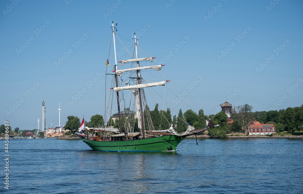 Green two mast sail boat leaving Stockholm for the archipelago