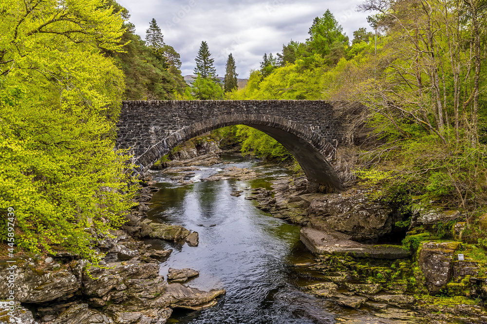A view towards the road bridge over the falls at Invermoriston, Scotland on a summers day