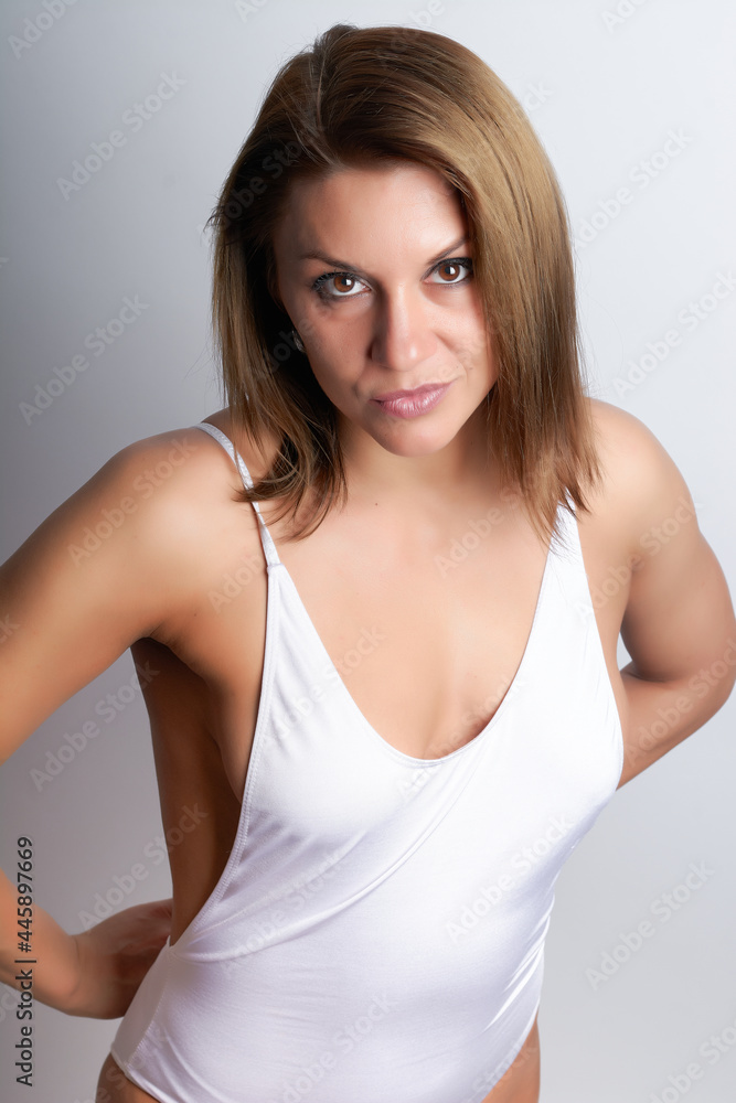 sports girl in a white swimsuit on a white background sports girl in a white swimsuit on a white background