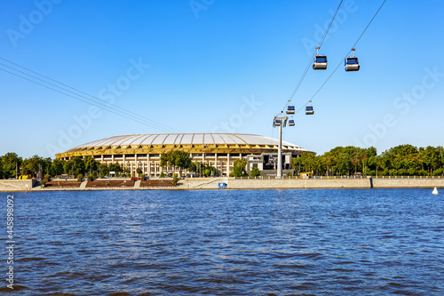 The large sports arena of the Luzhniki Olympic Complex and the cabins of the Moscow Cable Car on a sunny summer day. Moscow, Russia, July 2021