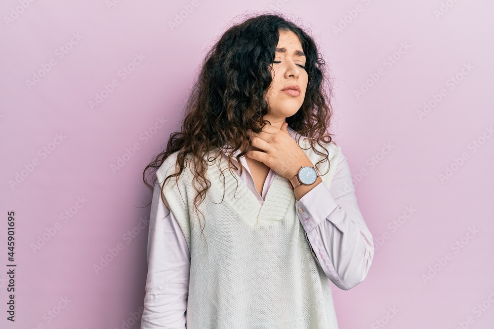 Young brunette woman with curly hair wearing casual clothes touching painful neck, sore throat for flu, clod and infection Young brunette woman with curly hair wearing casual clothes touching painful neck, sore throat for flu, clod and infection