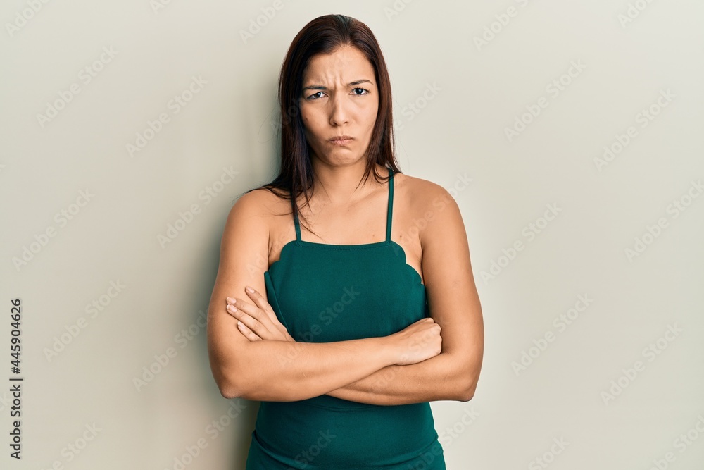 Young latin woman wearing casual clothes skeptic and nervous, disapproving expression on face with crossed arms. negative person. Young latin woman wearing casual clothes skeptic and nervous, disapproving expression on face with crossed arms. negative person.