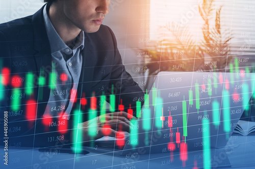 Handsome trader businessman who is carrying out a research on la