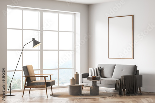 Mock up empty poster on the wall. Modern living room interior. Wooden floor and stylish furniture. Concept of contemporary design.