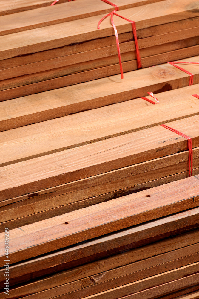 High angle view of wooden planks stack in vertical frame, construction material background