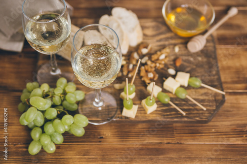 cheese, grapes and wine on wooden background 