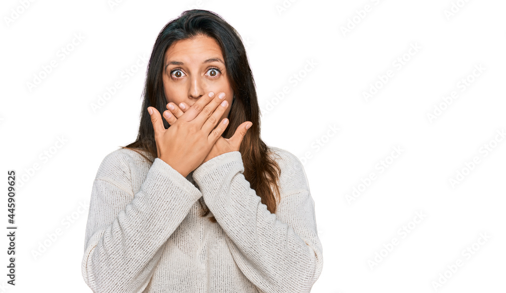 Beautiful hispanic woman wearing casual sweater shocked covering mouth with hands for mistake. secret concept. Beautiful hispanic woman wearing casual sweater shocked covering mouth with hands for mistake. secret concept.