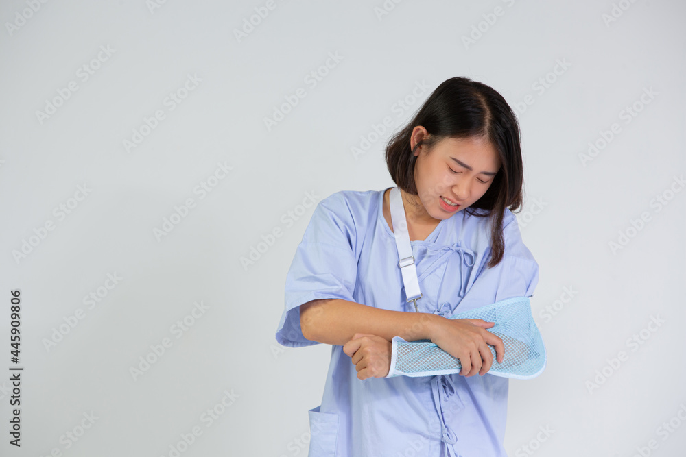 Young woman with a broken arm wearing an arm splint on white background Young woman with a broken arm wearing an arm splint on white background