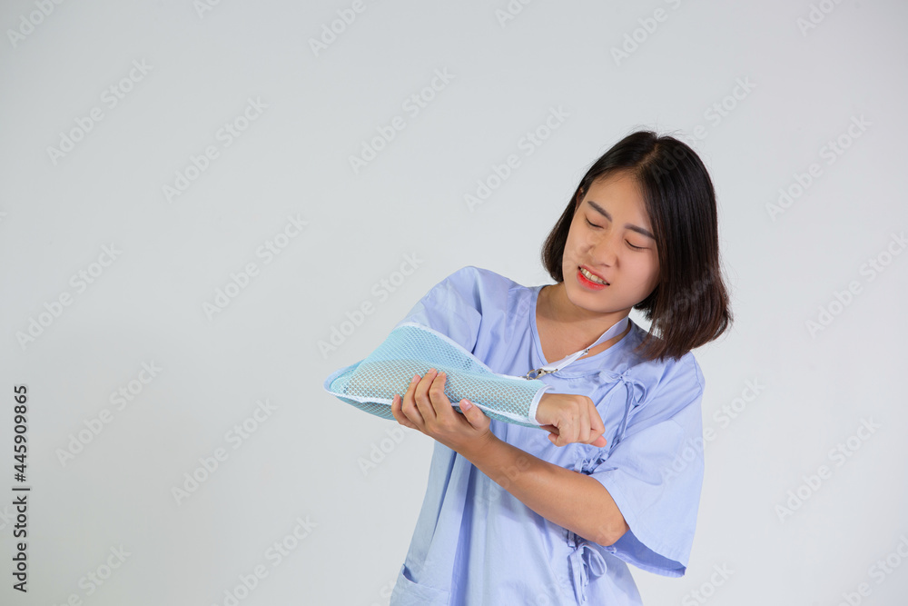 Young woman with a broken arm wearing an arm splint on white background Young woman with a broken arm wearing an arm splint on white background