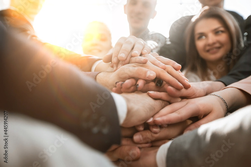 Obraz na płótnie close up. a group of young business people showing their unity w salonie